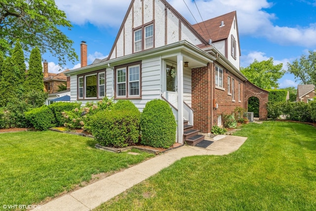 239 Imperial St, Park Ridge, IL 60068 - view of front of house featuring a front lawn, entry steps, brick siding, and a chimney