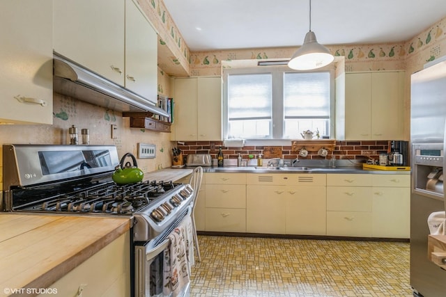 239 Imperial St, Park Ridge, IL 60068 - kitchen featuring appliances with stainless steel finishes, stainless steel countertops, cream cabinets, backsplash, and a sink