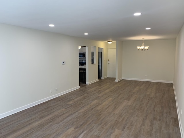 245 Park Ln Unit 208, Palatine, IL 60074 - unfurnished room with a chandelier, dark wood finished floors, recessed lighting, and baseboards
