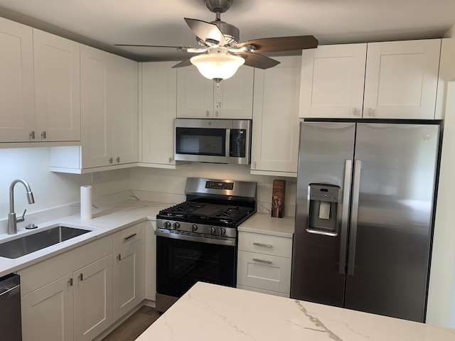 245 Park Ln Unit 208, Palatine, IL 60074 - kitchen featuring appliances with stainless steel finishes, a sink, white cabinets, and a ceiling fan