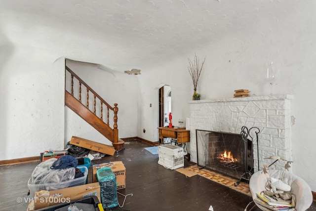 562 Byrd Rd, Riverside, IL 60546 - living area with a fireplace, stairs, baseboards, and arched walkways