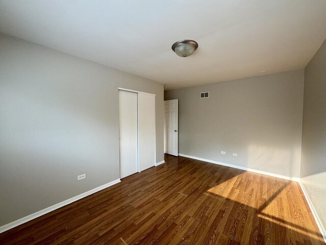 4230 Barry Ln, Oak Forest, IL 60452 - unfurnished bedroom featuring dark wood-style floors, baseboards, and a closet