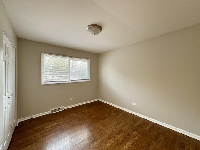 4230 Barry Ln, Oak Forest, IL 60452 - unfurnished bedroom with a closet, dark wood-style flooring, and baseboards