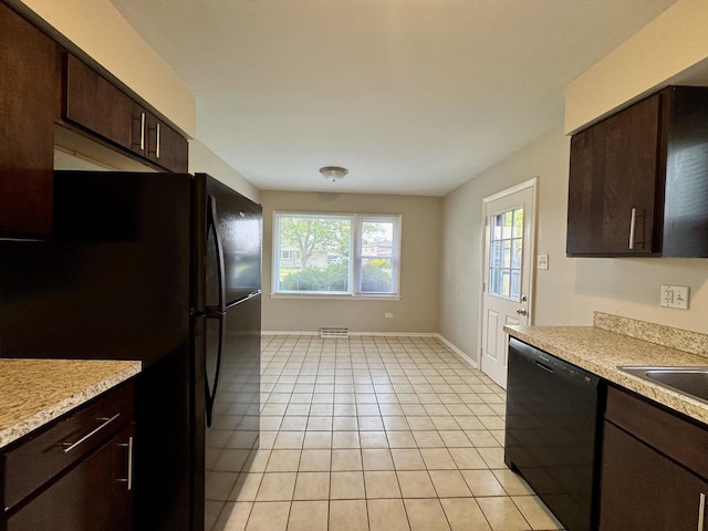 4230 Barry Ln, Oak Forest, IL 60452 - kitchen with black appliances, baseboards, light countertops, dark brown cabinets, and light tile patterned floors
