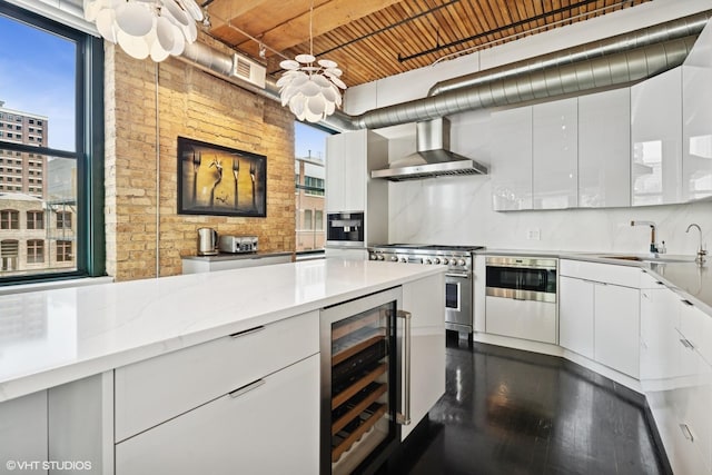 411 W Ontario St Unit 201-302, Chicago, IL 60654 - kitchen with wine cooler, wall chimney exhaust hood, range with two ovens, a sink, and white cabinets