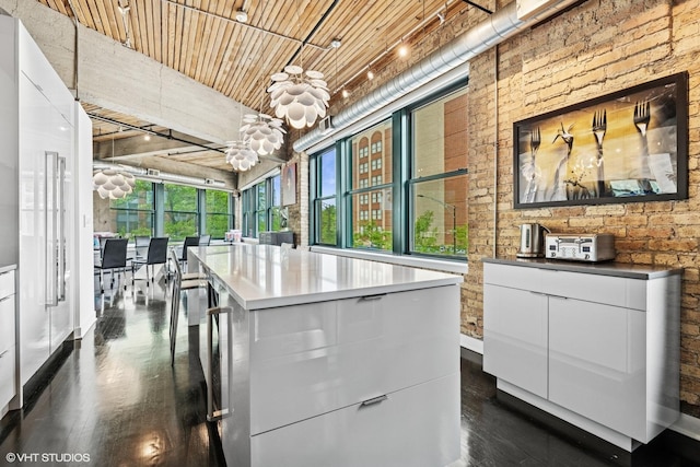 411 W Ontario St Unit 201-302, Chicago, IL 60654 - kitchen with a chandelier, white cabinets, dark wood-style flooring, wooden ceiling, and baseboards