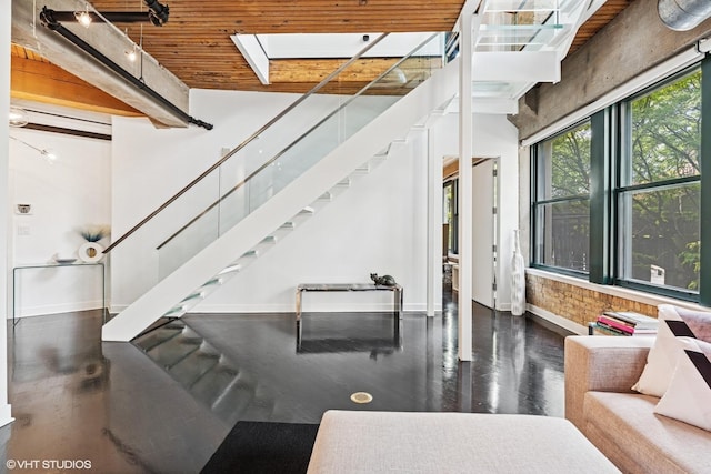 411 W Ontario St Unit 201-302, Chicago, IL 60654 - stairs with baseboards, wood finished floors, a skylight, and a high ceiling