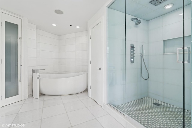 411 W Ontario St Unit 201-302, Chicago, IL 60654 - bathroom featuring a shower stall, a soaking tub, tile walls, tile patterned flooring, and recessed lighting