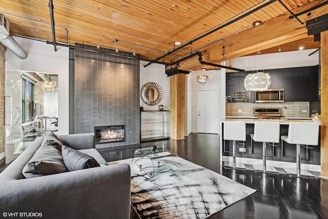 411 W Ontario St Unit 201-302, Chicago, IL 60654 - living area featuring a fireplace, a chandelier, wood ceiling, and wood finished floors