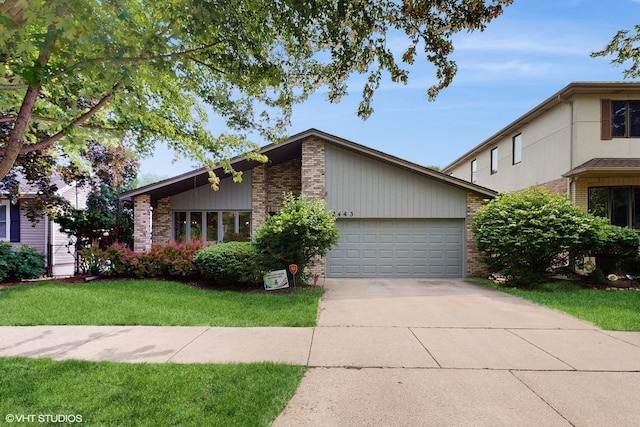 2443 Maple St, River Grove, IL 60171 - mid-century home with brick siding, an attached garage, concrete driveway, and a front lawn