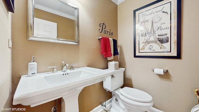2443 Maple St, River Grove, IL 60171 - half bathroom featuring toilet, ornamental molding, and baseboards