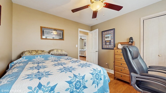 2443 Maple St, River Grove, IL 60171 - bedroom with wood finished floors, a desk, a ceiling fan, and baseboards