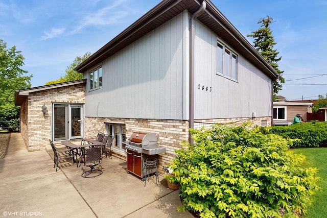 2443 Maple St, River Grove, IL 60171 - view of side of home featuring a patio area, brick siding, and outdoor dining area