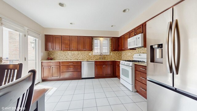 2443 Maple St, River Grove, IL 60171 - kitchen featuring appliances with stainless steel finishes, a sink, light countertops, decorative backsplash, and recessed lighting
