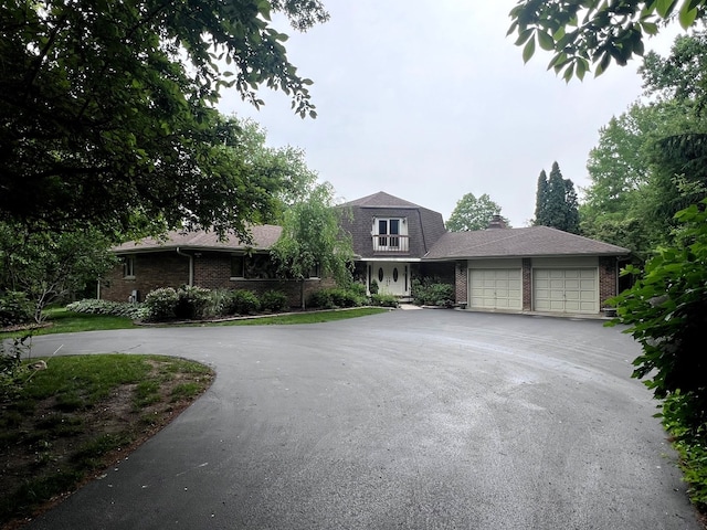 38W361 Binnie Rd, Dundee, IL 60118 - view of front of property with curved driveway, brick siding, and an attached garage