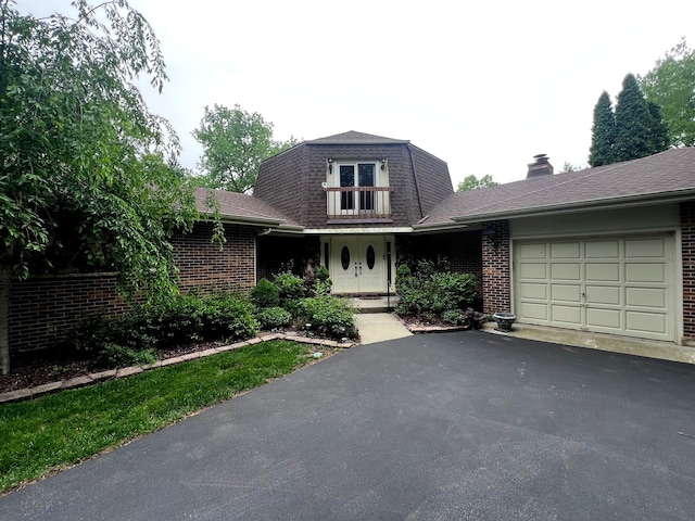 38W361 Binnie Rd, Dundee, IL 60118 - view of front of house with an attached garage, brick siding, asphalt driveway, and a shingled roof