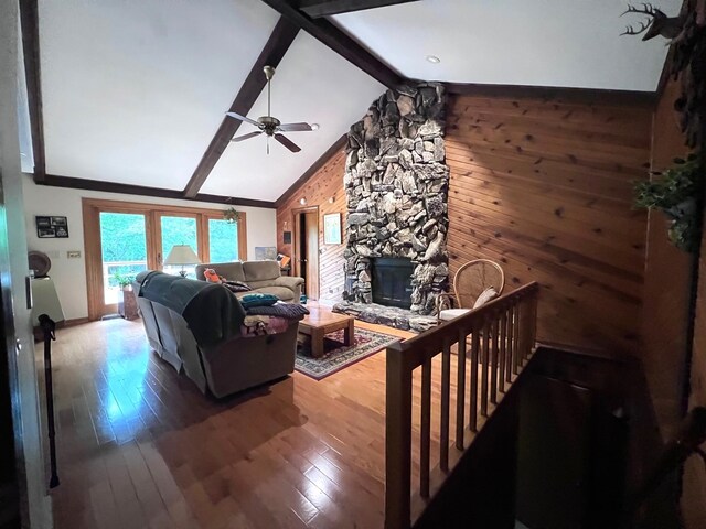 38W361 Binnie Rd, Dundee, IL 60118 - living area featuring a stone fireplace, ceiling fan, wood finished floors, wooden walls, and baseboards