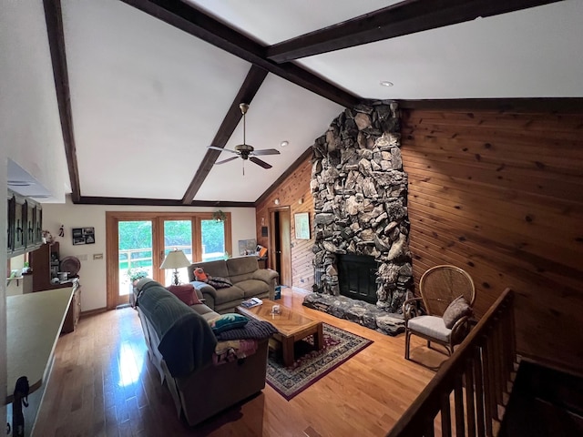 38W361 Binnie Rd, Dundee, IL 60118 - living room with a stone fireplace, ceiling fan, wood finished floors, baseboards, and wood walls