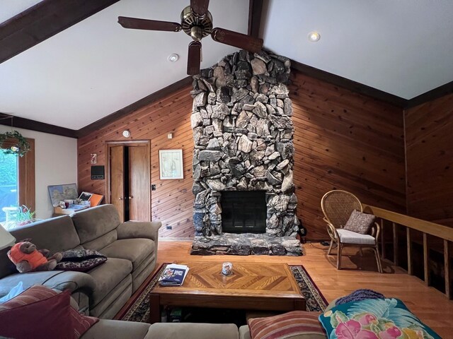 38W361 Binnie Rd, Dundee, IL 60118 - living area with wooden walls, a ceiling fan, a stone fireplace, and wood finished floors
