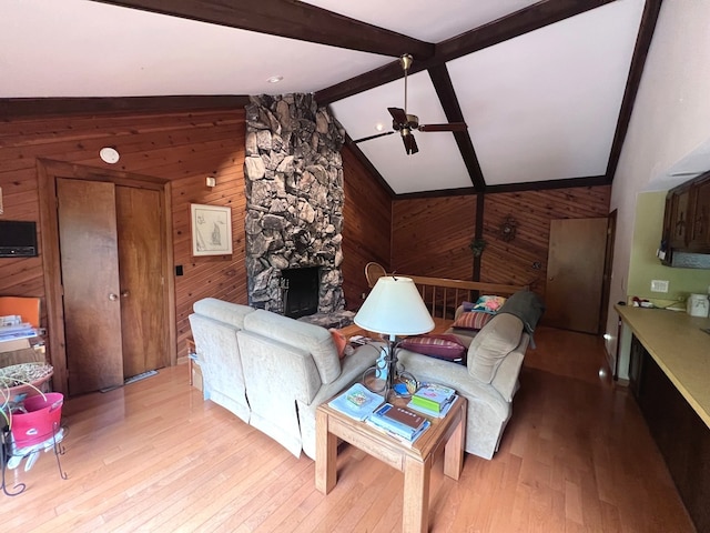 38W361 Binnie Rd, Dundee, IL 60118 - living area with wooden walls, a ceiling fan, light wood finished floors, and a stone fireplace