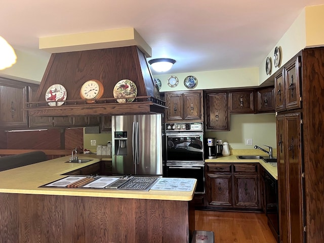 38W361 Binnie Rd, Dundee, IL 60118 - kitchen with black appliances, a peninsula, a sink, light countertops, and dark brown cabinets