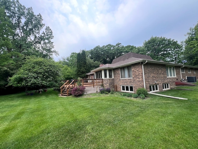 38W361 Binnie Rd, Dundee, IL 60118 - rear view of house featuring a deck, central air condition unit, brick siding, a lawn, and stairway