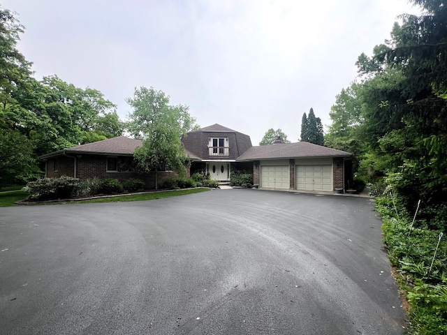 38W361 Binnie Rd, Dundee, IL 60118 - view of front of property featuring asphalt driveway, a garage, and brick siding
