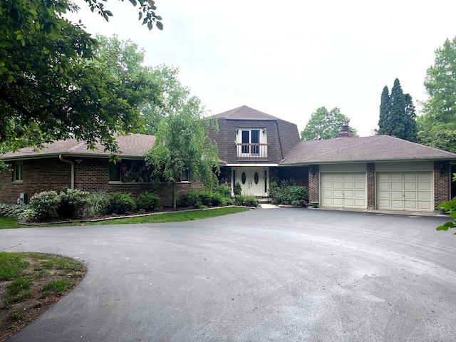 38W361 Binnie Rd, Dundee, IL 60118 - view of front of house featuring asphalt driveway, brick siding, and a garage