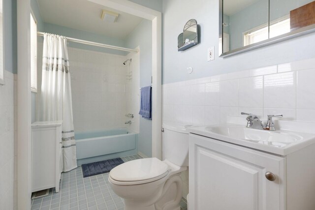 298 Fern Dr, Elk Grove Village, IL 60007 - bathroom with toilet, vanity, tile patterned floors, shower / bath combo, and tile walls