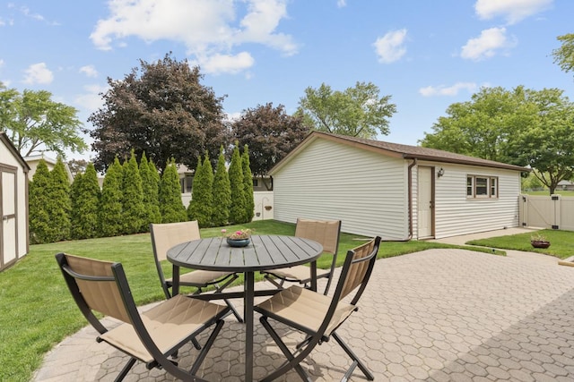 298 Fern Dr, Elk Grove Village, IL 60007 - view of patio featuring outdoor dining space, a gate, and an outbuilding