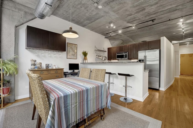 1110 W 15th St Unit 228, Chicago, IL 60608 - dining room featuring light wood-style floors, track lighting, and baseboards