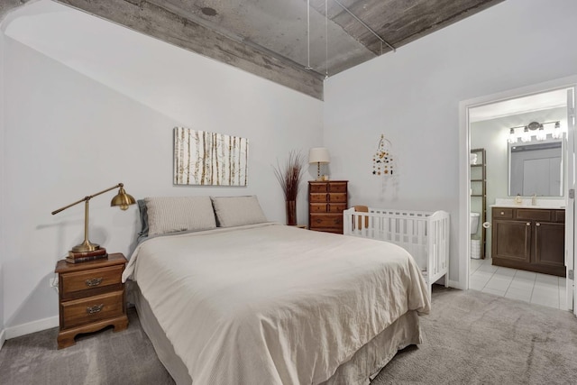 1110 W 15th St Unit 228, Chicago, IL 60608 - bedroom with light carpet, baseboards, ensuite bathroom, and a sink