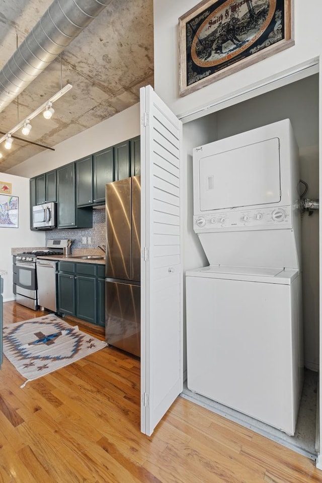 6 S Laflin St Unit 518, Chicago, IL 60607 - washroom featuring stacked washer / drying machine and light wood-style flooring