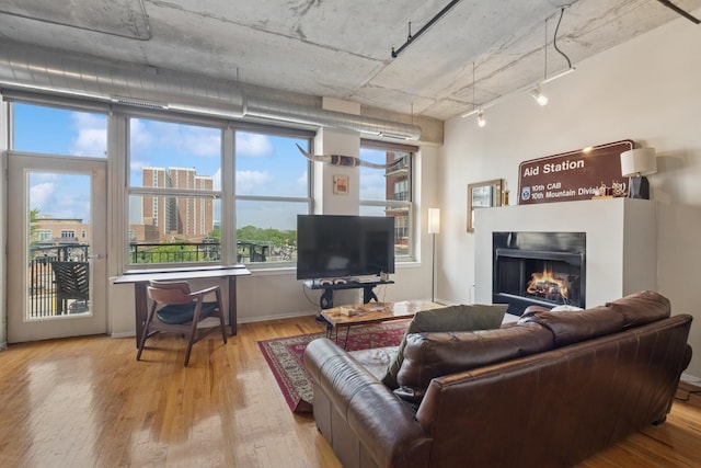 6 S Laflin St Unit 518, Chicago, IL 60607 - living area featuring hardwood / wood-style flooring, a lit fireplace, and track lighting