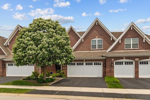 2140 Washington Dr, Northbrook, IL 60062 - view of front of home with driveway, brick siding, and roof with shingles