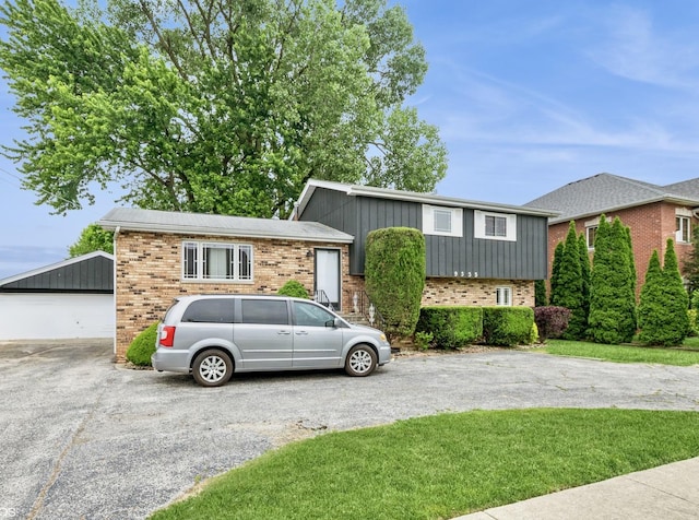 9335 Odell Ave, Bridgeview, IL 60455 - tri-level home featuring brick siding, an outbuilding, board and batten siding, and driveway