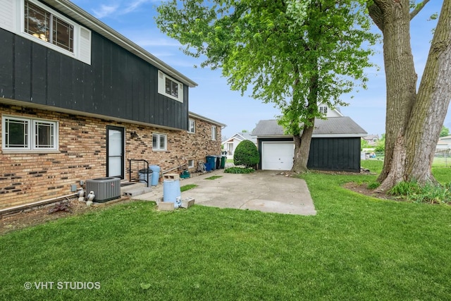 9335 Odell Ave, Bridgeview, IL 60455 - view of grassy yard featuring an outdoor structure, a garage, and a patio area