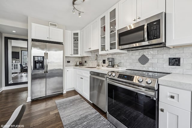 30 E Huron St Unit 3109, Chicago, IL 60611 - kitchen featuring stainless steel appliances, white cabinets, dark wood finished floors, and light stone countertops