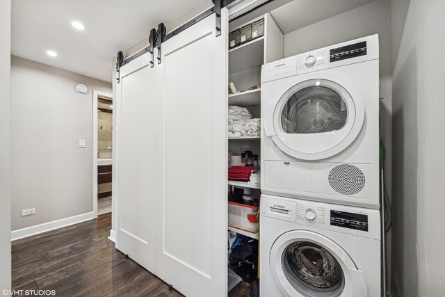 30 E Huron St Unit 3109, Chicago, IL 60611 - laundry room with estacked washer and dryer, a barn door, recessed lighting, dark wood-style floors, and baseboards