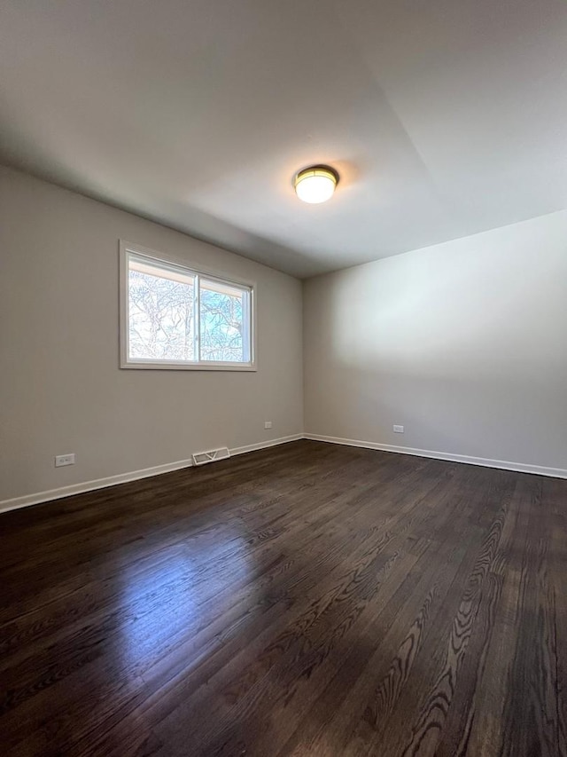 14425 Sanderson Ave, Dolton, IL 60419 - unfurnished room with dark wood-style flooring and baseboards