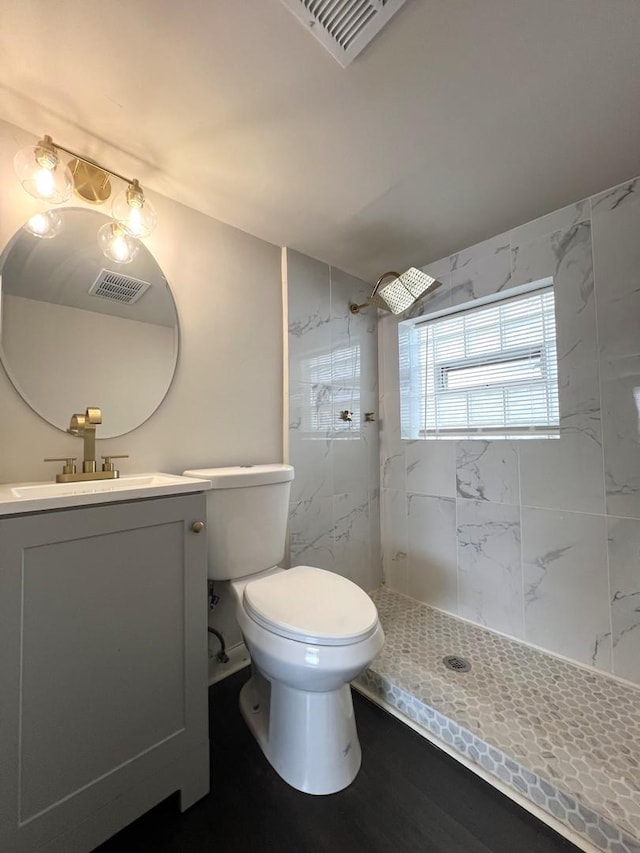 14425 Sanderson Ave, Dolton, IL 60419 - full bathroom featuring a tile shower, toilet, and vanity