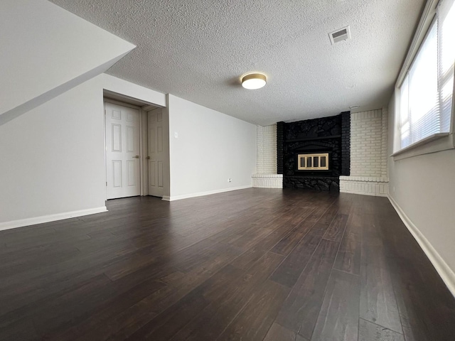 14425 Sanderson Ave, Dolton, IL 60419 - unfurnished living room with dark wood-style floors, a fireplace, a textured ceiling, and baseboards