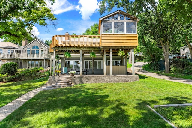 5110 W Lake Shore Dr, Wonder Lake, IL 60097 - rear view of house featuring a lawn, a deck, and a patio area