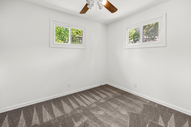 5110 W Lake Shore Dr, Wonder Lake, IL 60097 - empty room with healthy amount of natural light, dark colored carpet, and a ceiling fan