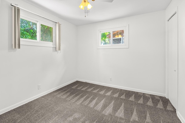 5110 W Lake Shore Dr, Wonder Lake, IL 60097 - unfurnished room with dark colored carpet, plenty of natural light, and ceiling fan