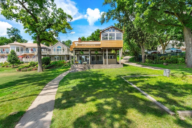 5110 W Lake Shore Dr, Wonder Lake, IL 60097 - back of property with a sunroom, a yard, a chimney, and a deck
