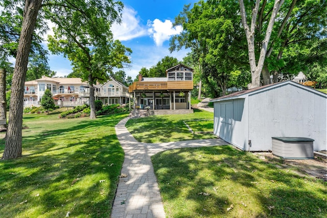 5110 W Lake Shore Dr, Wonder Lake, IL 60097 - back of house with a sunroom, a lawn, a wooden deck, and a storage shed