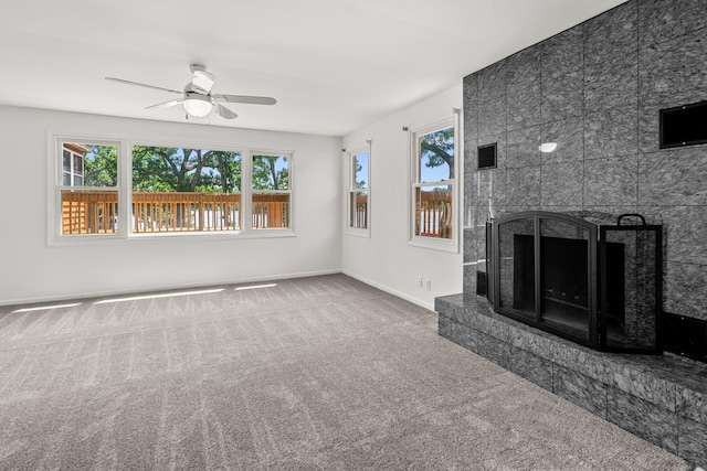 5110 W Lake Shore Dr, Wonder Lake, IL 60097 - unfurnished living room with a tiled fireplace, carpet flooring, and ceiling fan