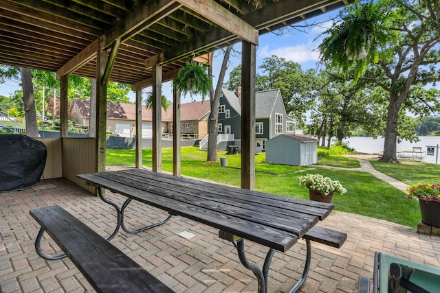 5110 W Lake Shore Dr, Wonder Lake, IL 60097 - view of patio / terrace featuring a storage shed, area for grilling, and a residential view