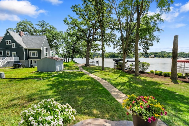 5110 W Lake Shore Dr, Wonder Lake, IL 60097 - view of green lawn with a water view and a storage shed